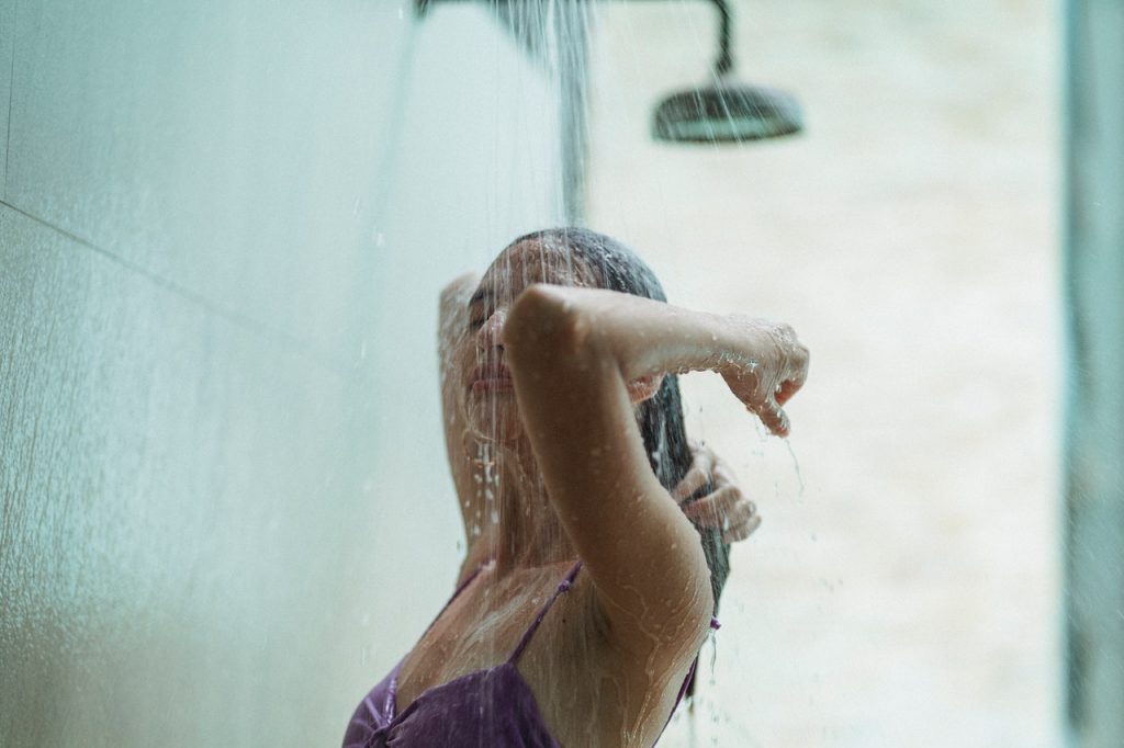 young woman rinsing hair in the shower