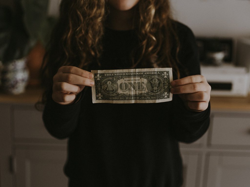 woman holding a dollar
